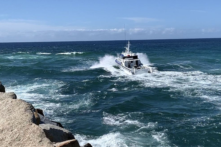 Boat in the ocean. Stay safe when crossing coastal bars with essential tips for boaters. Learn how to navigate safely and avoid incidents.