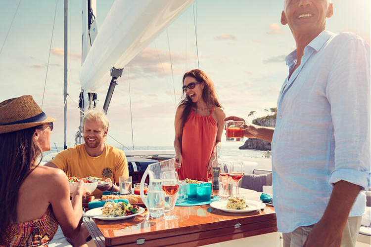 Prepared dining table with view of boats in the ocean, menu planning for boat meals