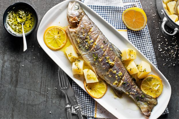 Prepared fish fillet with lemon, ginger, and butter. How to cook fish on a boat.